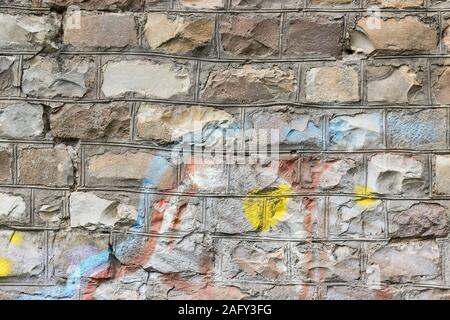 Fragment of colored graffiti painted on a brick wall. Texture. Abstract background for design. Stock Photo