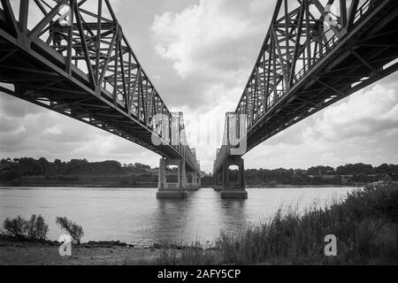 Archival black and white view under the Natchez Mississippi bridges and the Mississippi river.  Photo taken in May 1996. Stock Photo