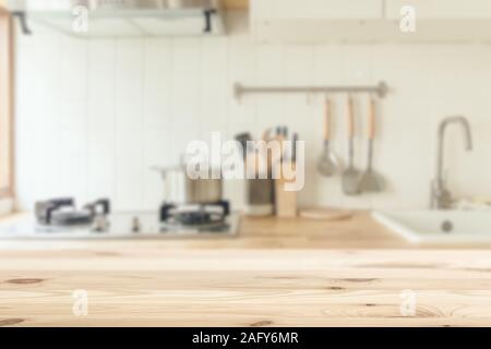 Kitchen background blur with wooden top table clean white for kitchenware montage advertising banner layout. Stock Photo