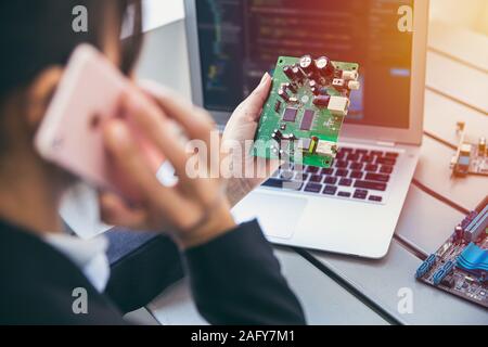 Electronic hardware engineer business person calling with chip supplier about digital circuit board product design. Stock Photo
