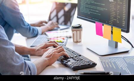 Young startup Programmers Sitting At Desks Working On Computers screen for Developing programming and coding to find solution to problem on New Applic Stock Photo