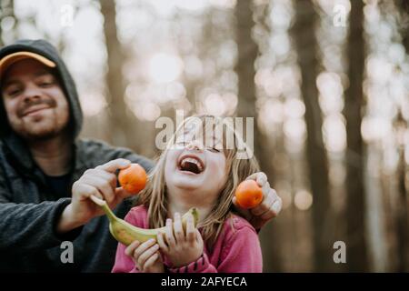 young girl laughing with dad outside Stock Photo