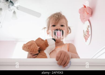toddler girl wakes up from her nap Stock Photo