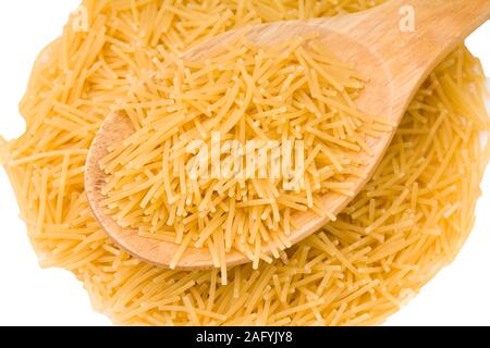 Wooden cooking spoons filled with noodle ona white background Stock Photo
