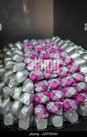 Close up of wonderfully arranged chocolates in wraps Stock Photo