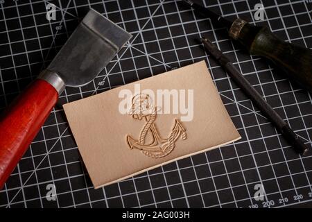 work on leather goods using leather tools Stock Photo