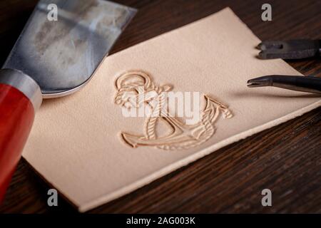 work on leather goods using leather tools Stock Photo