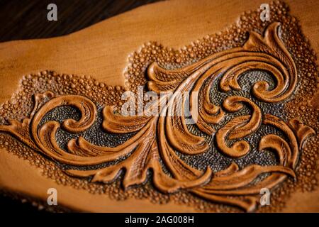 embossed pattern on the leather in the workshop Stock Photo