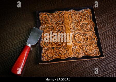 embossed pattern on the leather in the workshop Stock Photo