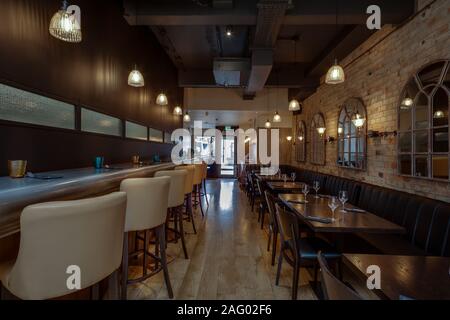 Cozy wooden interior of restaurant, copy space. Comfortable modern dining place, contemporary design background Stock Photo