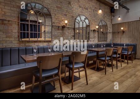 Cozy wooden interior of restaurant, copy space. Comfortable modern dining place, contemporary design background Stock Photo