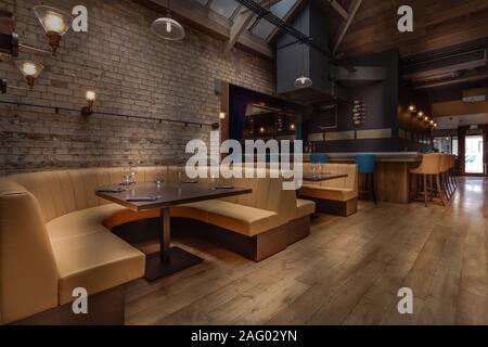 Cozy wooden interior of restaurant, copy space. Comfortable modern and discrete dining place, contemporary design background Stock Photo
