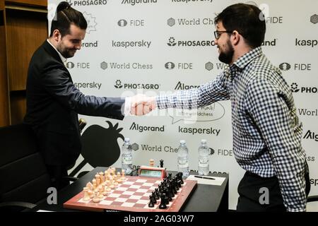 Jerusalem, Israel. 17th December, 2019. IAN NEPOMNIACHTCHI (L), 29, of Russia, shakes hands with MAXIME VACHIER LAGRAVE (R), 30, of France, at the opening of Round 3, Game 1, semi-finals, of the final leg of the World Chess Championship cycle at Jerusalem's Notre Dame Center. Credit: Nir Alon/Ģ����ý Live News Stock Photo