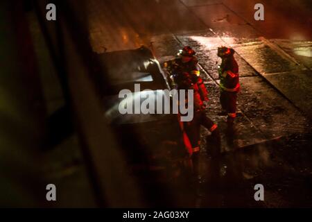 New York City Firefighters douse a car fare on Brooklyn, NY's Brooklyn Queens Expressway Stock Photo