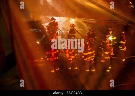 New York City Firefighters douse a car fare on Brooklyn, NY's Brooklyn Queens Expressway Stock Photo