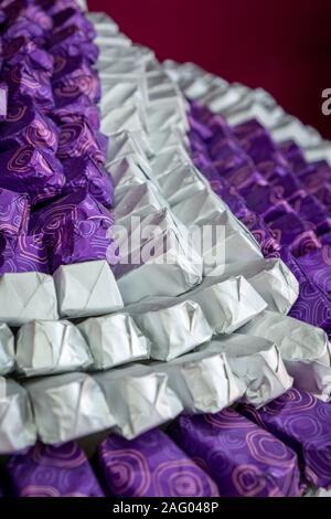 Close up of wonderfully arranged chocolates in wraps Stock Photo