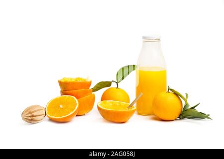 A bottle of orange juice and halved oranges on a white background Stock Photo