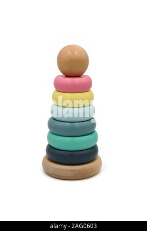 Wooden ring stacking toy with colored rings and a ball on the top. Stock Photo