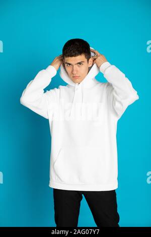 Young man in a white hoodie. Mock-up. Stock Photo