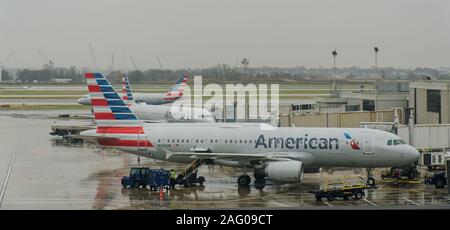 Philadelphia, PA - Nov. 22, 2019: American Airlines airplanes are at the gate and one taxiing at the Philadelphia international Airport on a rainy day Stock Photo