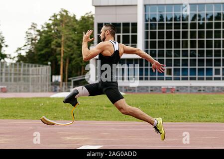 physically disabled athlete with prosthetic legs long jump in athletics