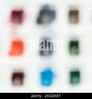 Blurred background of a watercolor set paints with different colors. Stock Photo