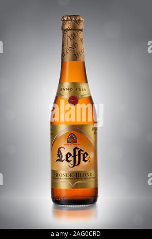 UKRAINE, KYIV - APRIL 6, 2013. Bottle of Leffe Blond beer on a gray background. Stock Photo