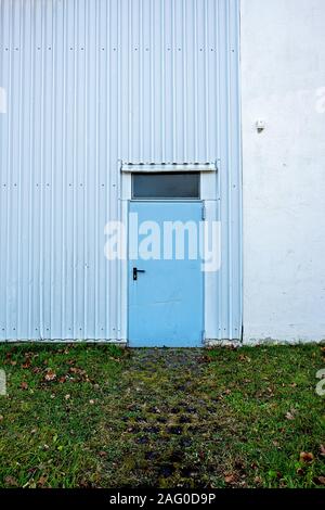 light blue steel door to a warehouse in rural areas Stock Photo