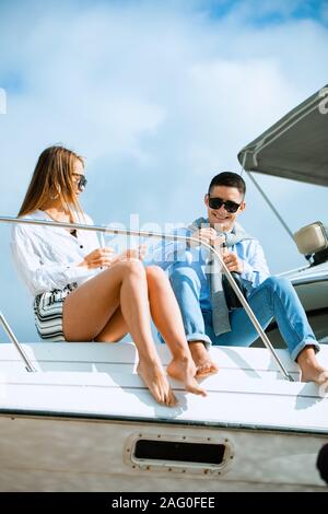 Two young tourists having fun on boat tour in the summertime Stock Photo