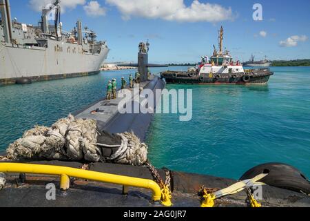 The U.S. Navy Los Angeles-class fast attack submarine USS Key West prepare to moor to the Lewis and Clark-class dry cargo and ammunition ship USNS Richard E. Byrd at Naval Base Guam December 10, 2019 in Santa Rita, Guam. Naval Base Guam is home to four Los Angeles-class attack submarines in the 7th Fleet and supports allied operations in Asia. Stock Photo