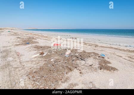 Garbage and trash left on the beach by people and from the sea. Plastic pollution and environmental issue Stock Photo