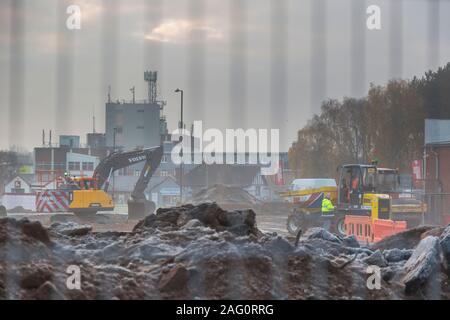 UK building site on a cold, misty, frosty, winter morning in December. British building site with people working. Stock Photo