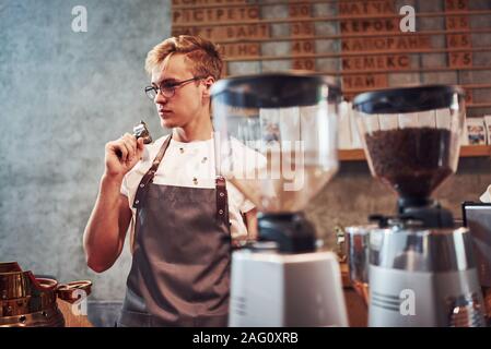 Young male cafe worker indoors. Conception of business and service Stock Photo