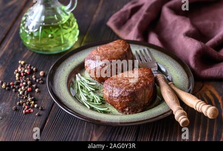 Filet mignon with fresh rosemary and peppercorn on the plate Stock Photo