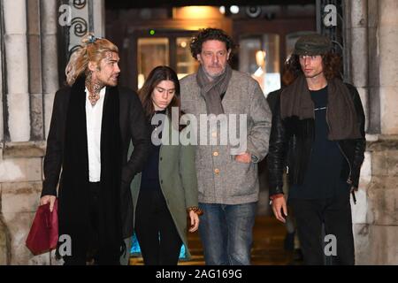 Marco Pierre White (centre right) leaves the Royal Courts of Justice in London accompanied by his children Marco White Jr (left) and Luciano White (right), as the chef and his estranged wife Matilde are embroiled in a High Court row over money. Stock Photo