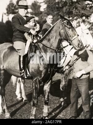 Early 20th century vintage press photograph - Italian fascist leader Benito Mussolini and one of this sons on horseback at Villa Torlonia, Rome, c.1920s Stock Photo