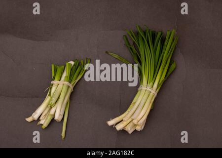 Green Onions on black table, top view and copy space Stock Photo