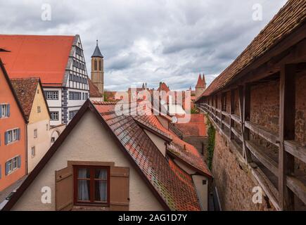 Medieval houses with red tile roof of Rothenburg ob der Tauber Old Town as seen from city wall corridor. Rothenburg is one of the most popular travel Stock Photo