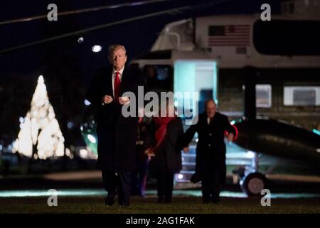 U.S President Donald Trump walks across the South Lawn after arriving back from the 120th Army-Navy football game aboard Marine One at the White House December 14, 2019 in Washington, DC. Stock Photo