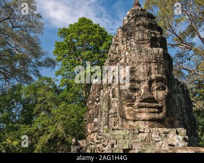 A giant stone face statue near the Victory Gate at Angkor Thom, near Siem Reap in Cambodia. Stock Photo