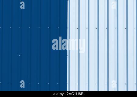 Brightly colored industrial warehouse exterior wall as background. Color of the year 2020 classic blue toned Stock Photo