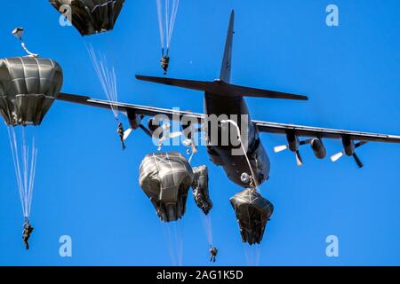 EDE, NETHERLANDS - SEP 21, 2019: Group of military parachutist paratroopers jumping out of a transport plane during the Operation Market Garden memori Stock Photo
