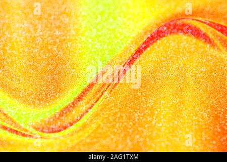 Red and yellow glitter wave. Christmas gold abstract background. Stock Photo