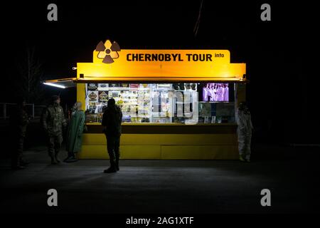 Workers of the Chernobyl Exclusion Zone in front of a commercial souvenir shop at the Checkpoint Dytyatky, the entrance for tourists and visitors to the zone. The government tries to encourage tourism in the area after President Volydymyr Zelensky signed a July decree designating Chernobyl an official tourist attraction. More than 87,000 people have visited Chernobyl until october 2019, up from 72,000 in 2018. Chernobyl Exclusion Zone, Checkpoint Dytyatky, Invankiv Raion, Kiev Oblast, Ukraine Stock Photo