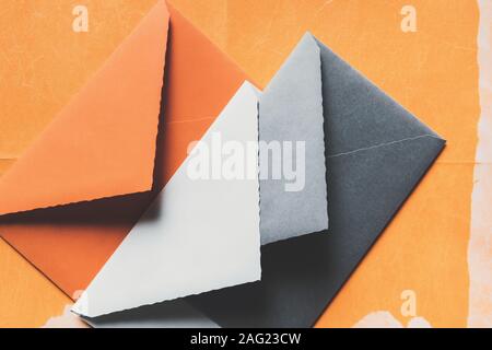 Color envelopes on orange paper, texture background Stock Photo