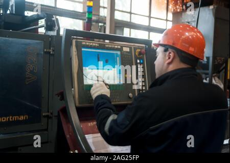 Industrial worker operating control panel system Stock Photo