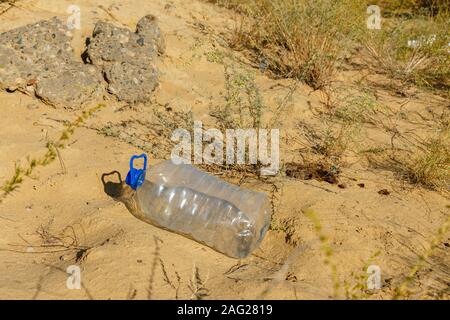 empty plastic bottle lies on the sand, plastic bottle Stock Photo