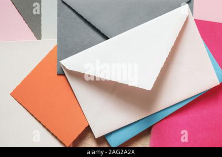 Various colors envelopes and greeting card on the table Stock Photo