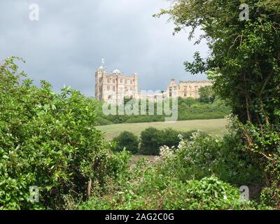 Bolsover Castle keep (The 'Little Castle') and ruined riding school to right viewed from surrounding Derbyshire farmland in summer. Stock Photo