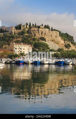 Chateau de Cassis castle on a cliff-top in Cassis port town, view from the port. South of France. Château de Cassis, 13th Century French castle travel Stock Photo